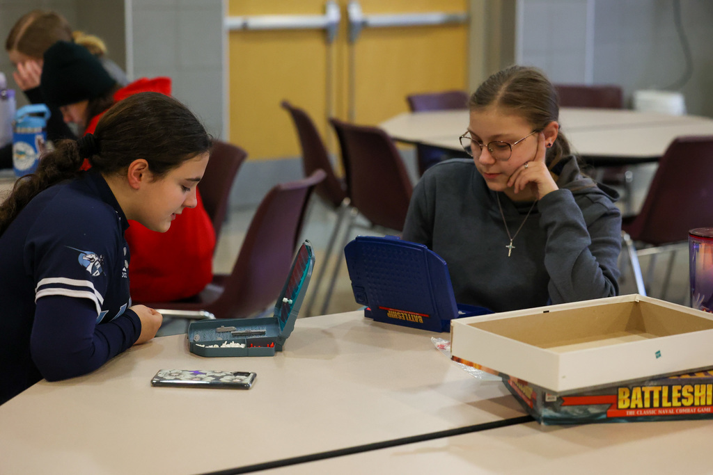 students concentrate and play the game battleship