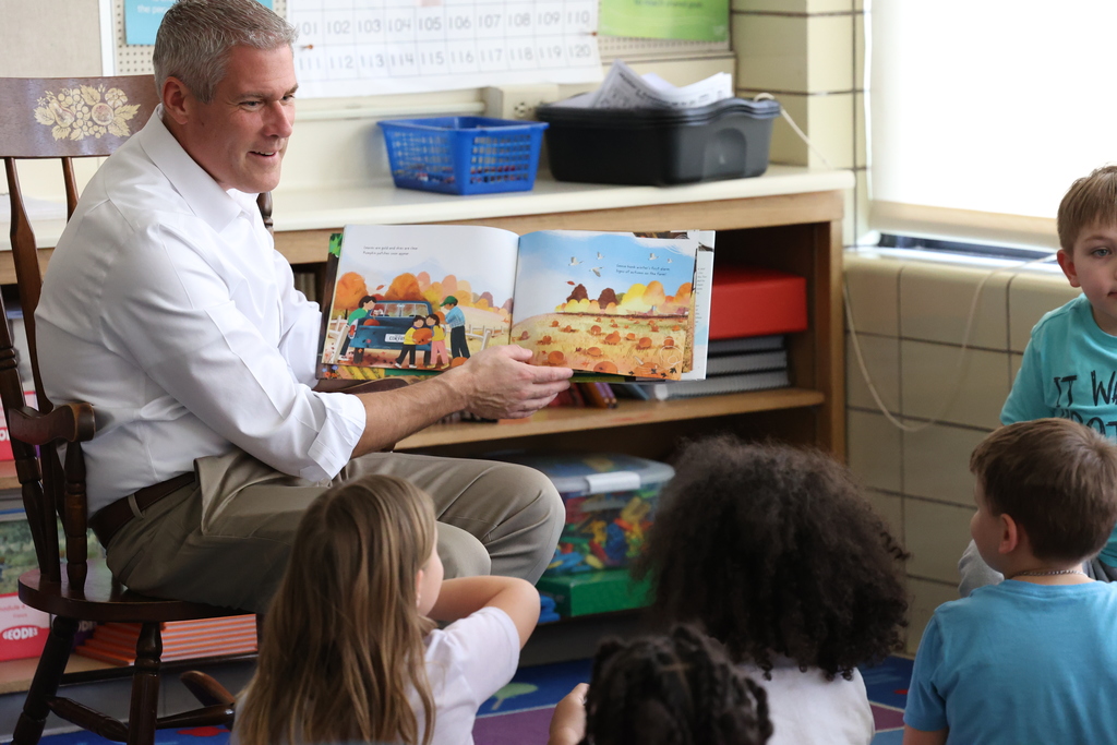 Monroe County Executive Adam Bello opens book and reads story to students