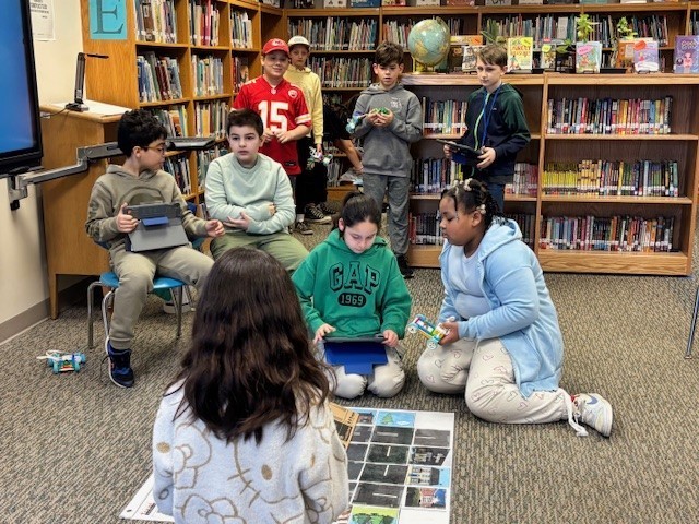 Students presenting their robots and obstacle courses