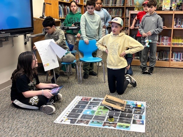 Students presenting their robots and obstacle courses