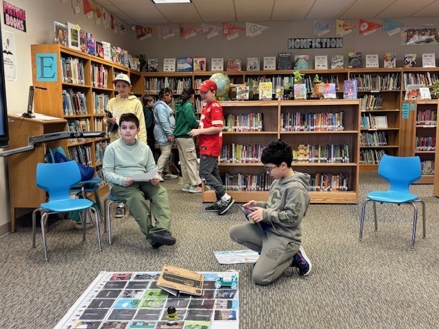 Students presenting their robots and obstacle courses