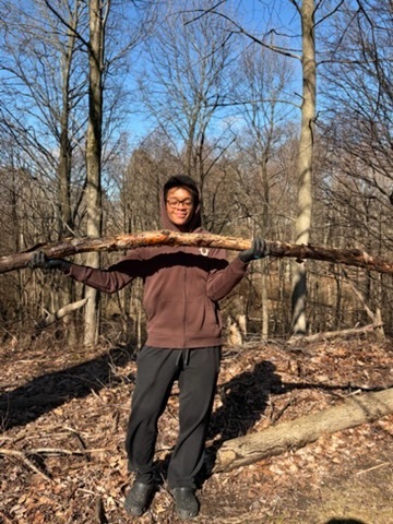 Students participating in give back day cleaning up the community and working with children