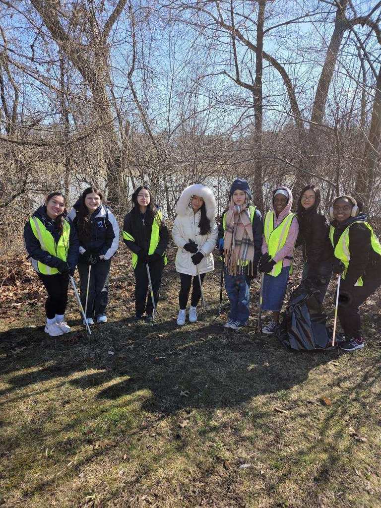 Students participating in give back day cleaning up the community and working with children