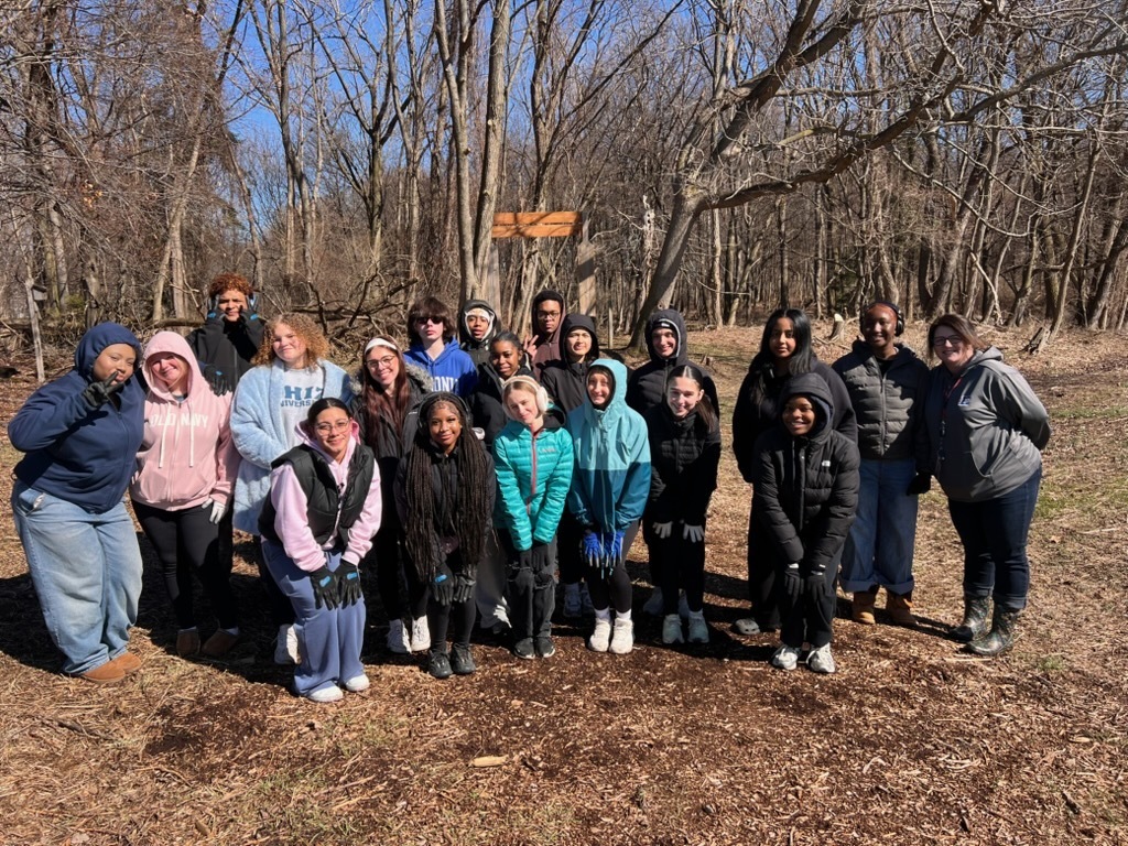 Students participating in give back day cleaning up the community and working with children