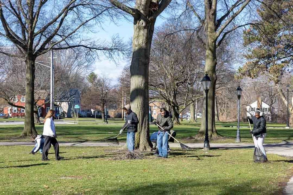 Students participating in give back day cleaning up the community and working with children