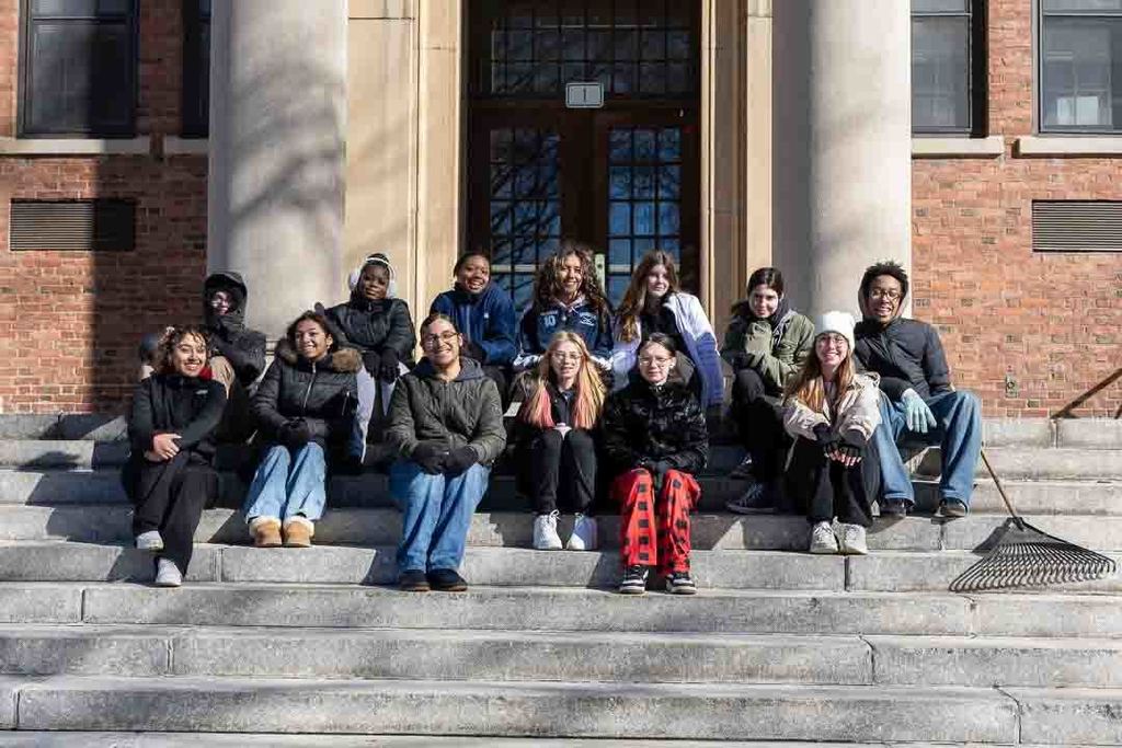 Students participating in give back day cleaning up the community and working with children