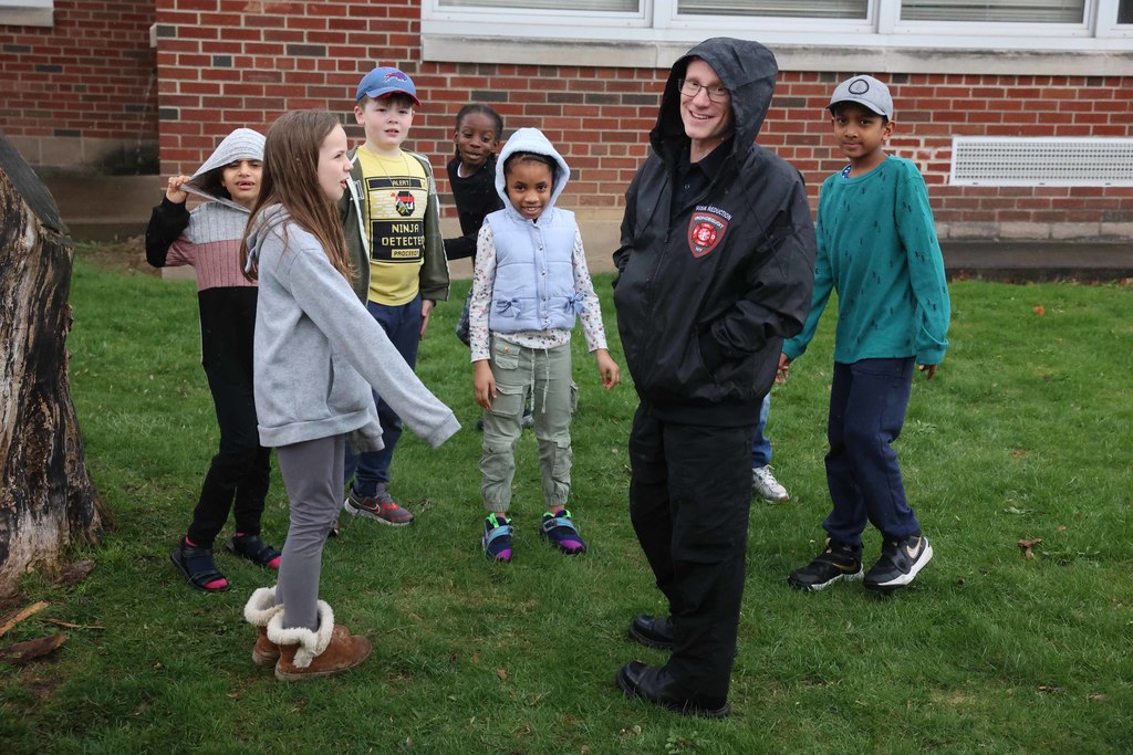 students gather at the meeting spot with firefighter