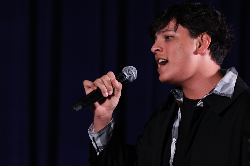 singer sings into microphone