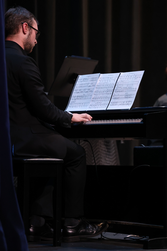 piano player reads music and plays a solo