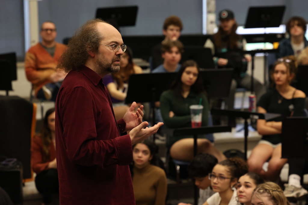 close up shot of speaker talking to students in music room 