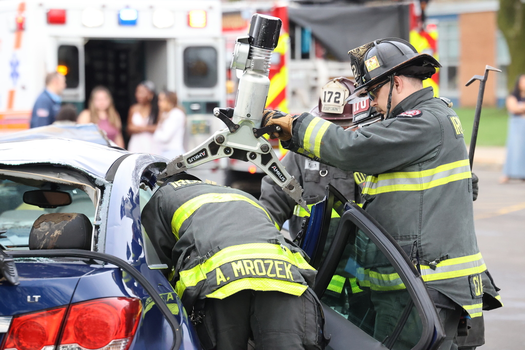 fire fighters pry open a car in a reinactment of a DWI crash 