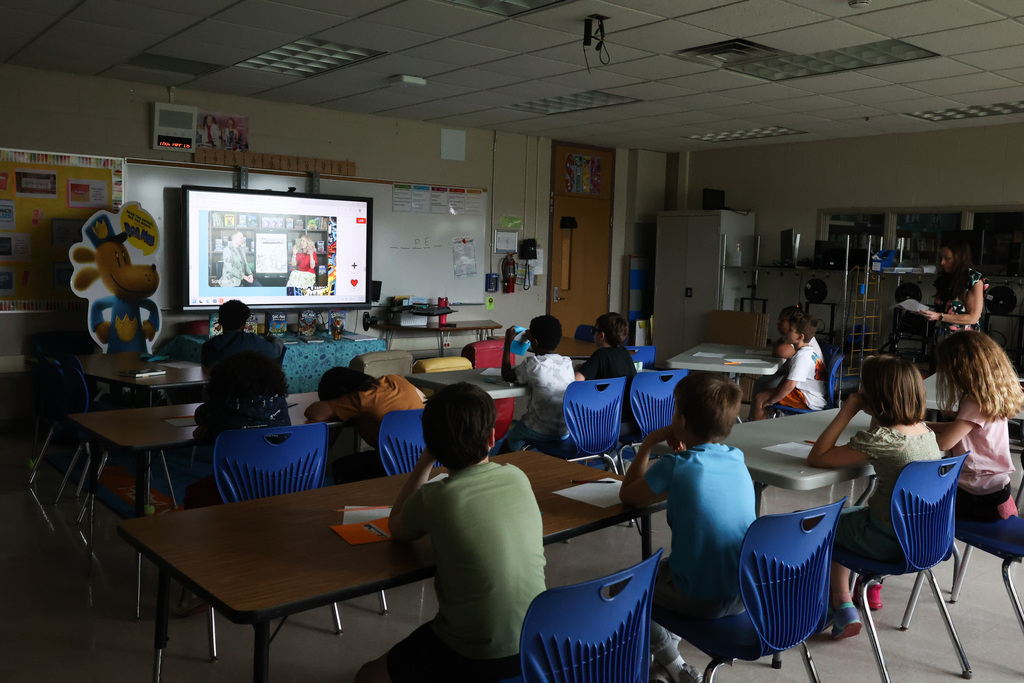 students gather to watch author talk about their books