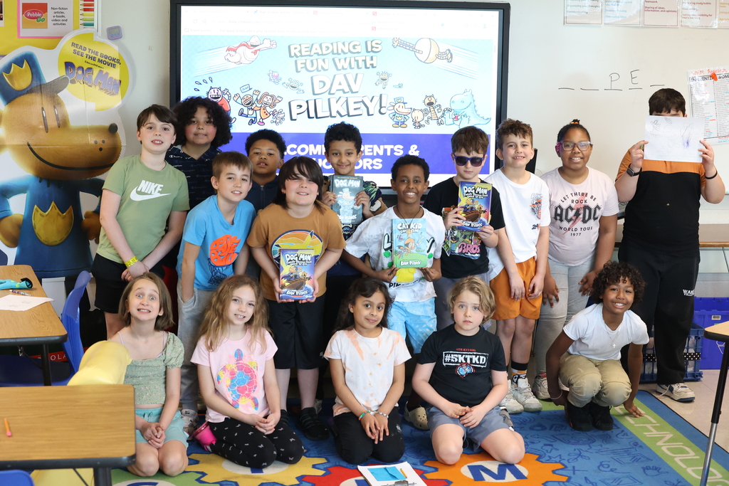Students pose with books after a virtual session of reading is fun with Dav Pilkey!