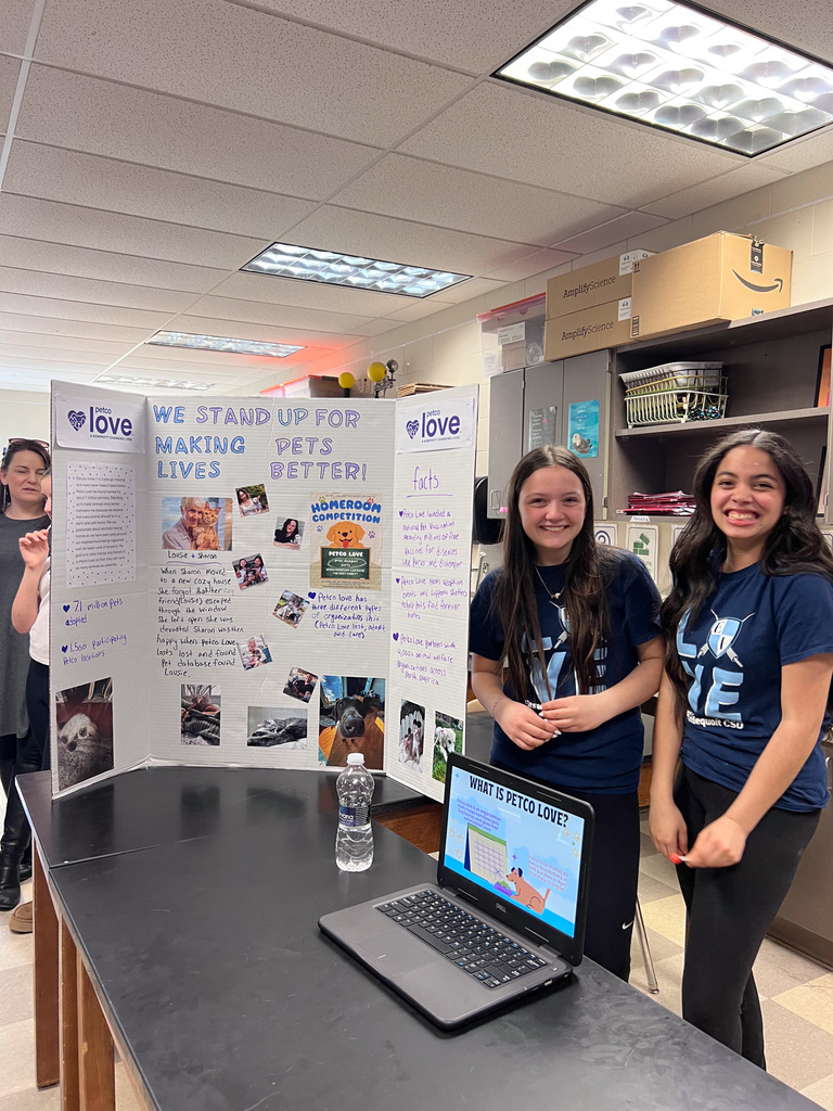Students smile with presentation board about pets we stand up tfor making pets lifes better 