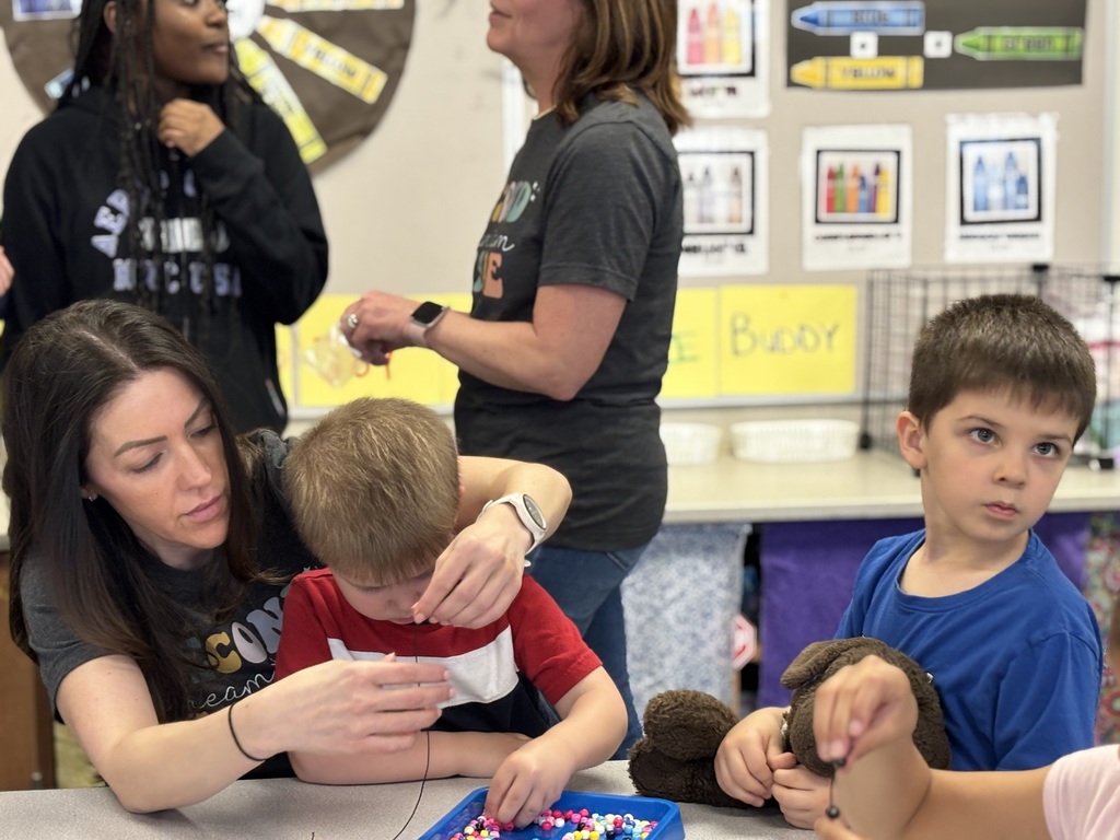 students and families make beaded bracelets