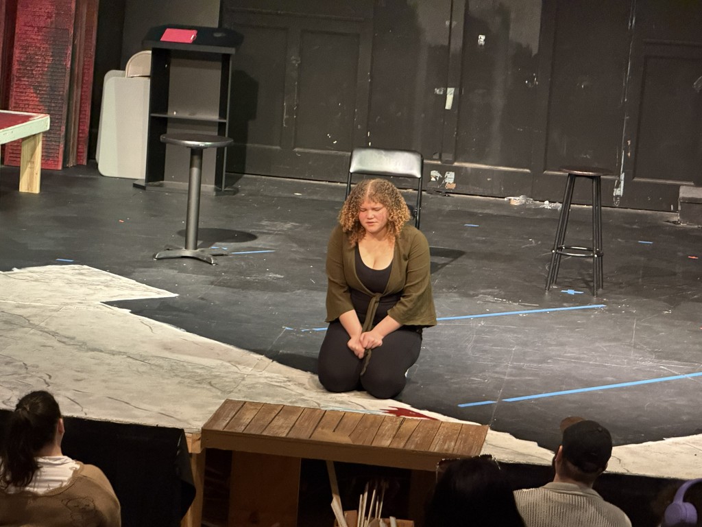 student sings in the middle of the stage