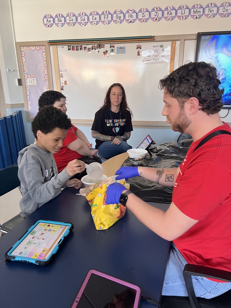 teachers and students work on filling pots with soil for planting