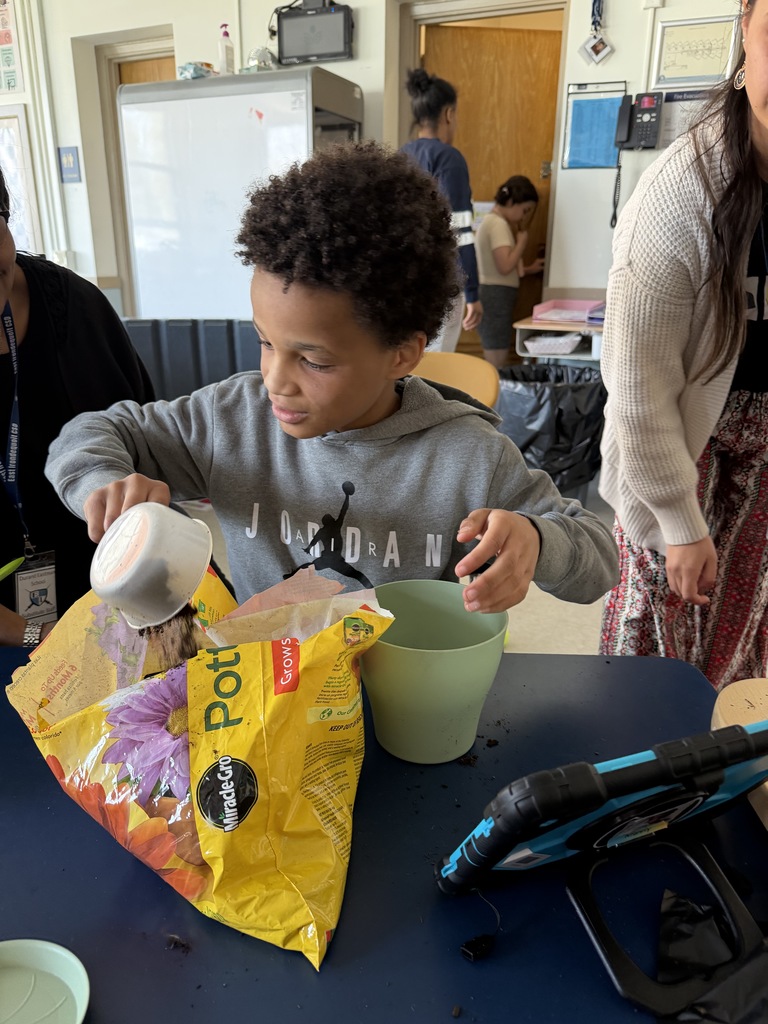 student works on grabbing soil for potted plant