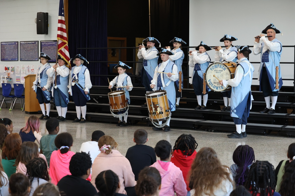 Students listen to the Towpath Volunteers Fife & Drum Corps 
