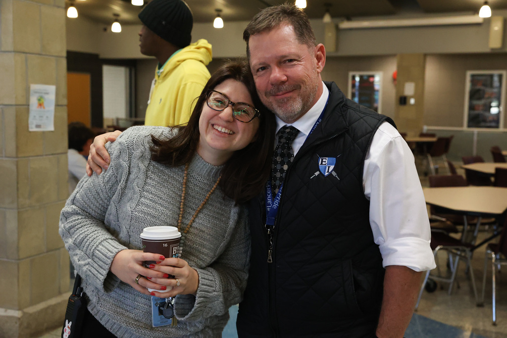 principals hold coffee and pose for a photo