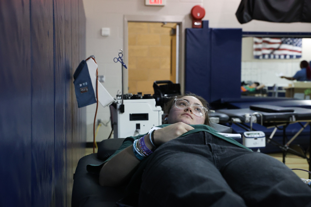 Student lays while getting blood drawn