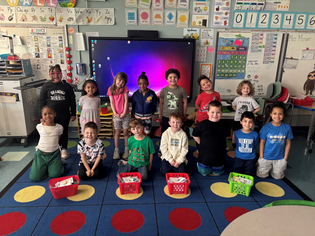 Students smile with cards they created 