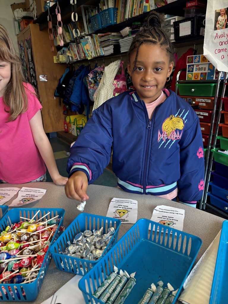 student smiles and picks out candy for a card
