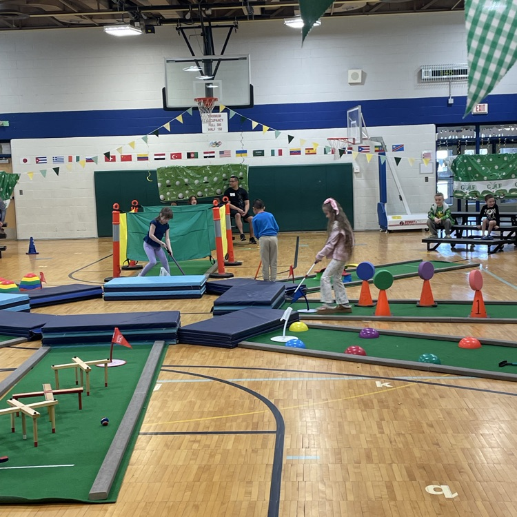 kid playing mini golf
