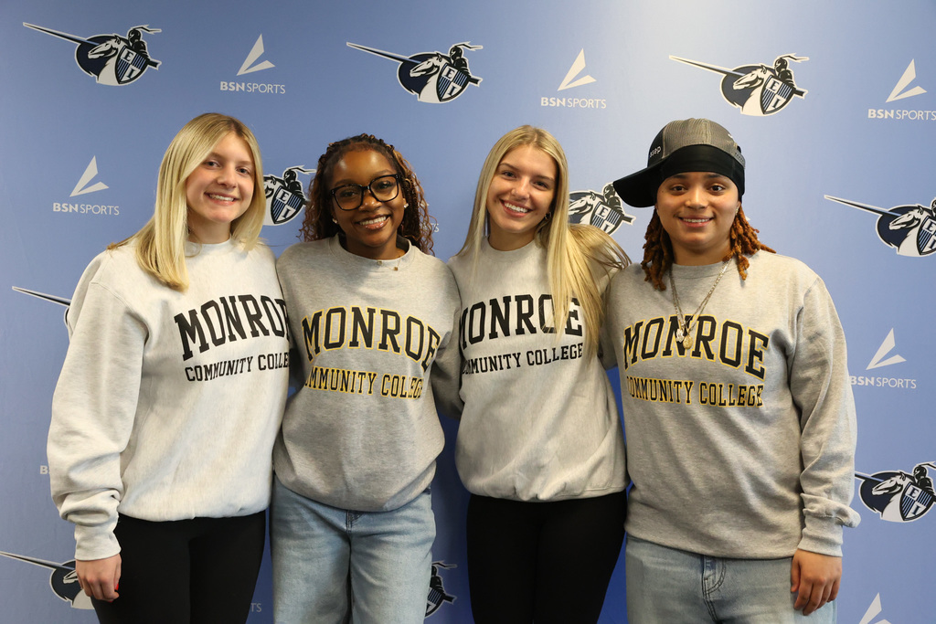 Students wear MCC college sweatshirts for a photo