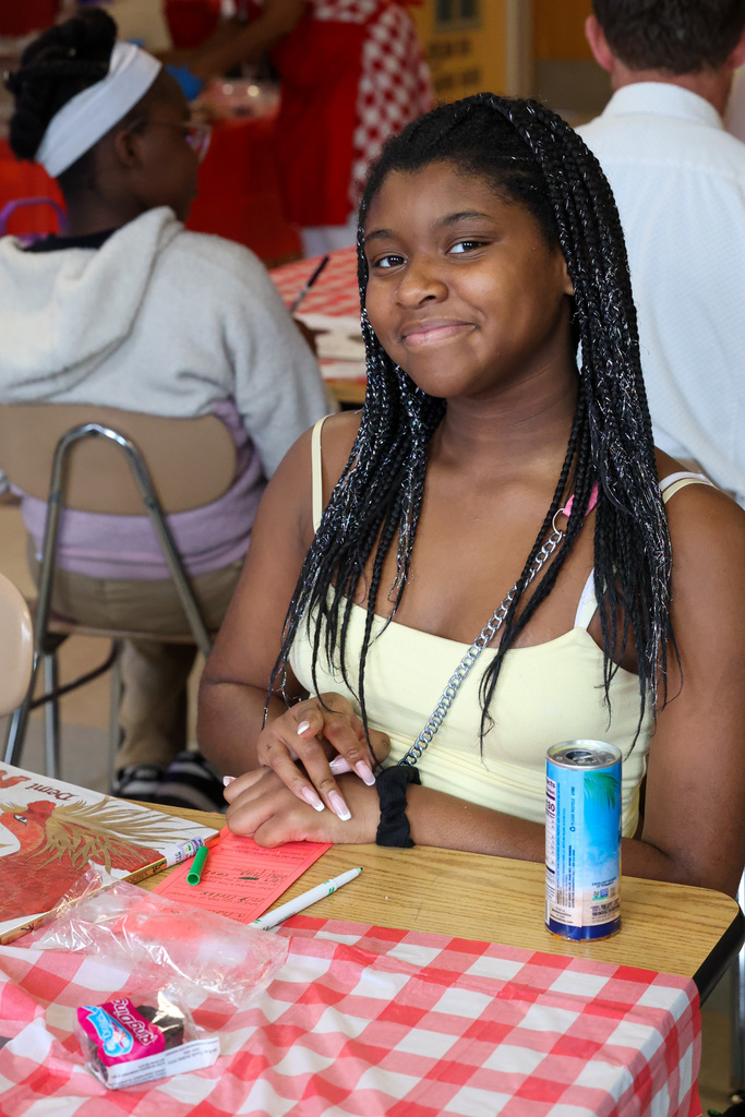 student smiles while working on assignment