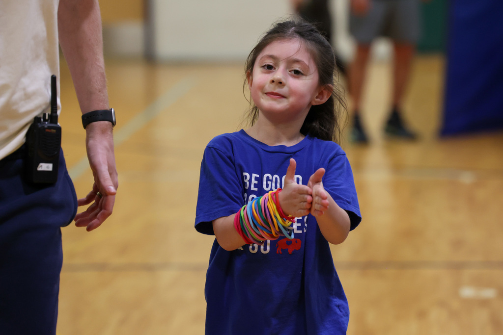 student claps after participating in Fun Run