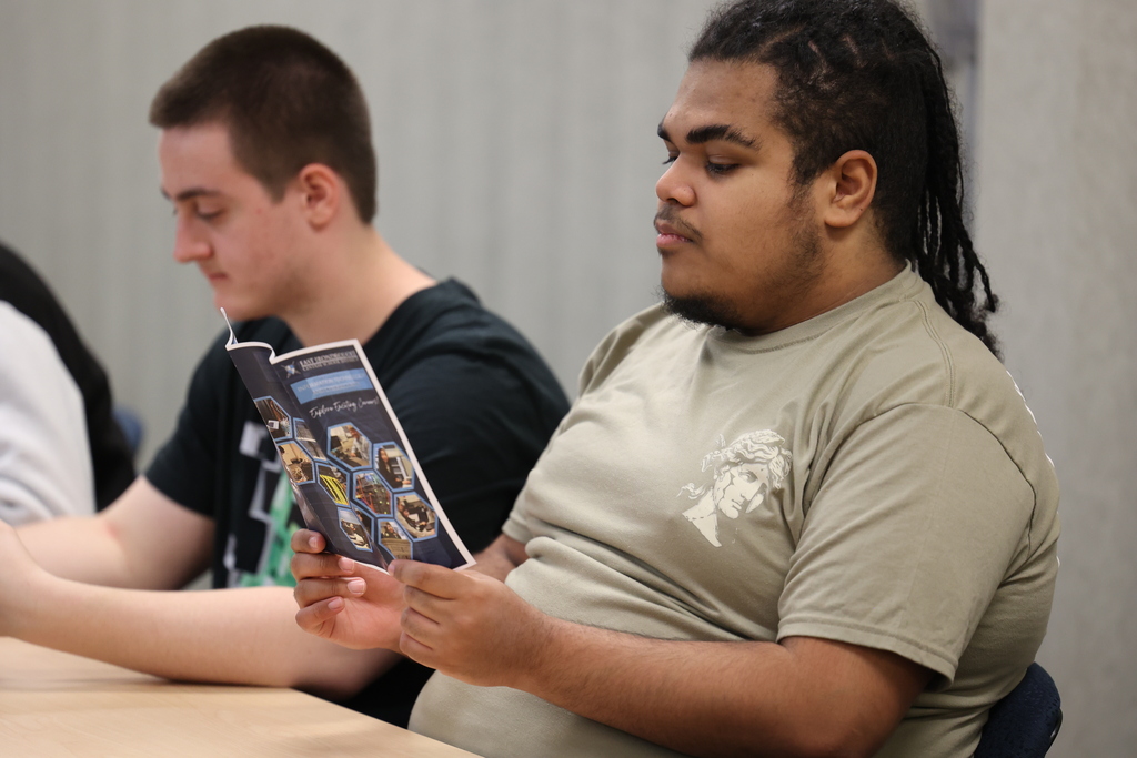 Student looks at IT pamphlet