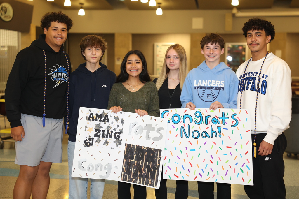 Students hold posters up 