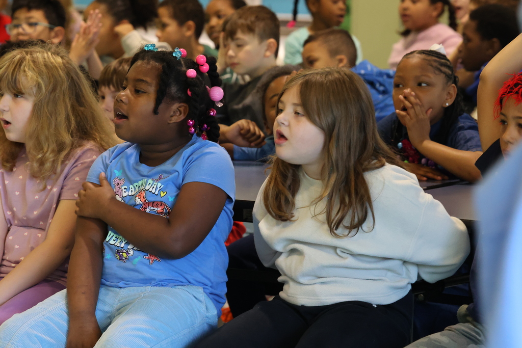 students shout an answer out to a question during a presentation