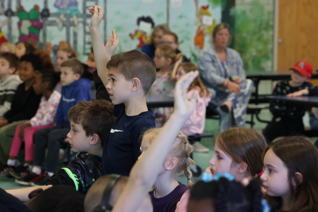 student raises hand during presentation 
