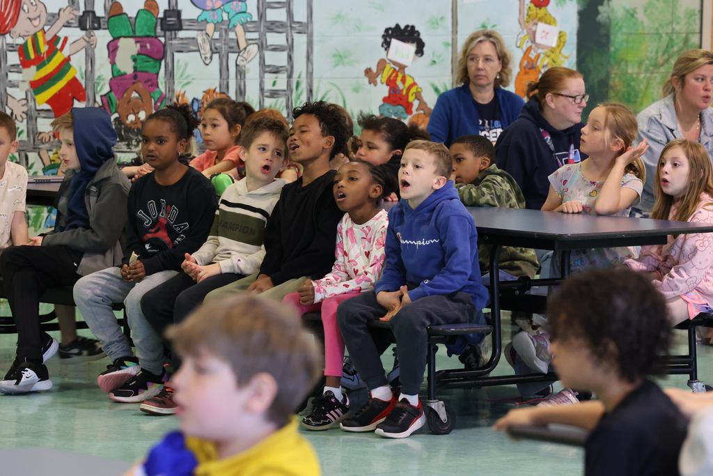 students shout an answer out to a question during a presentation