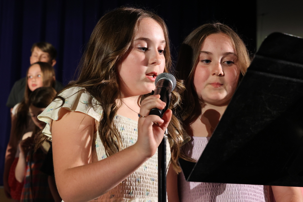 students speak into microphone