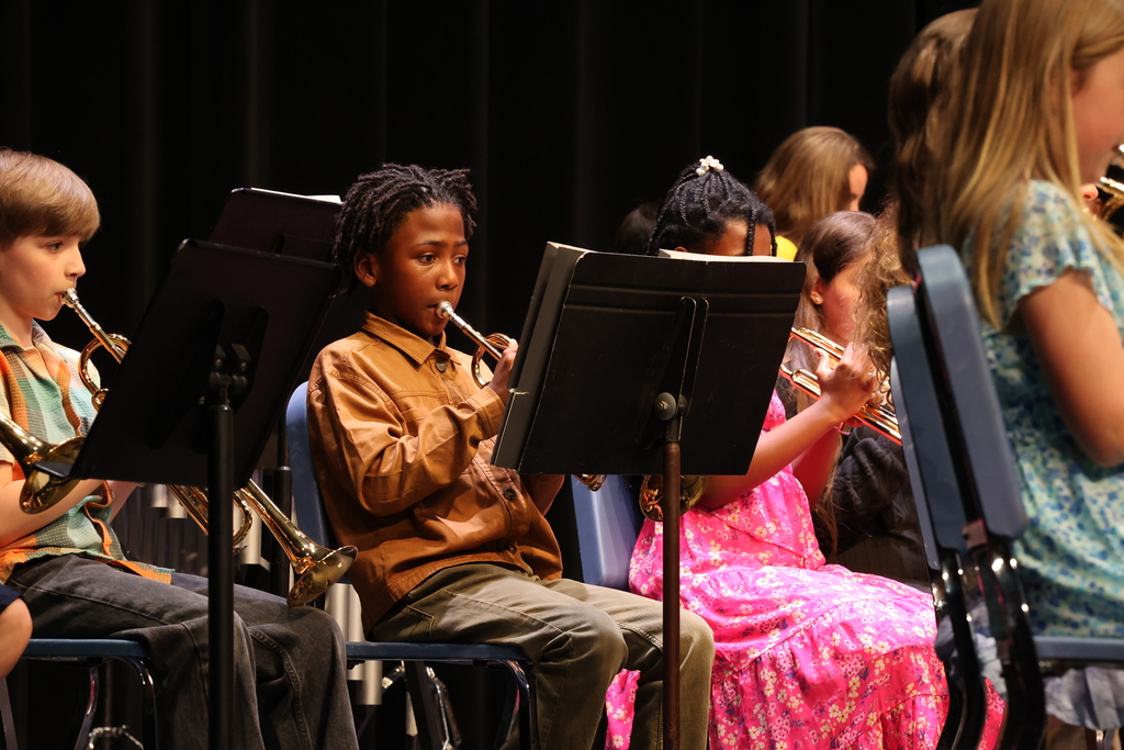 student plays the trumpet on stage