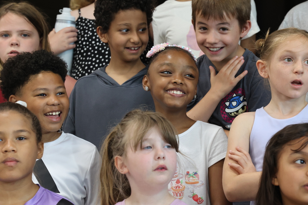 students smile during a concert performance