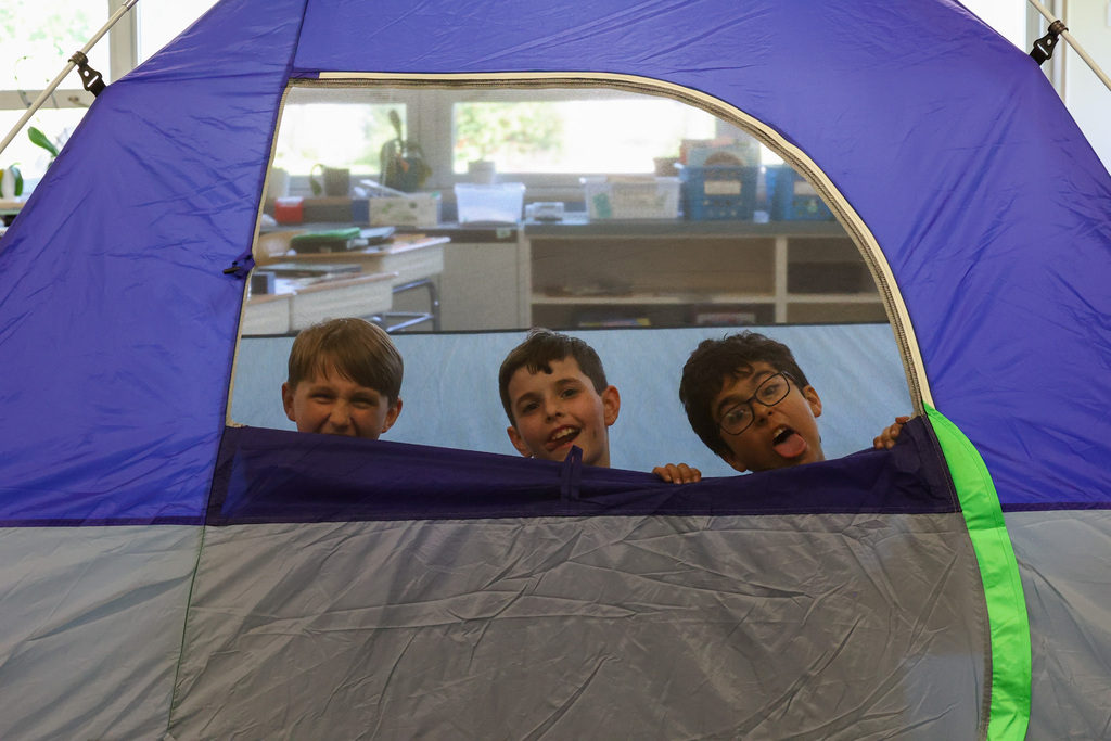 students make funny faces while in tent door