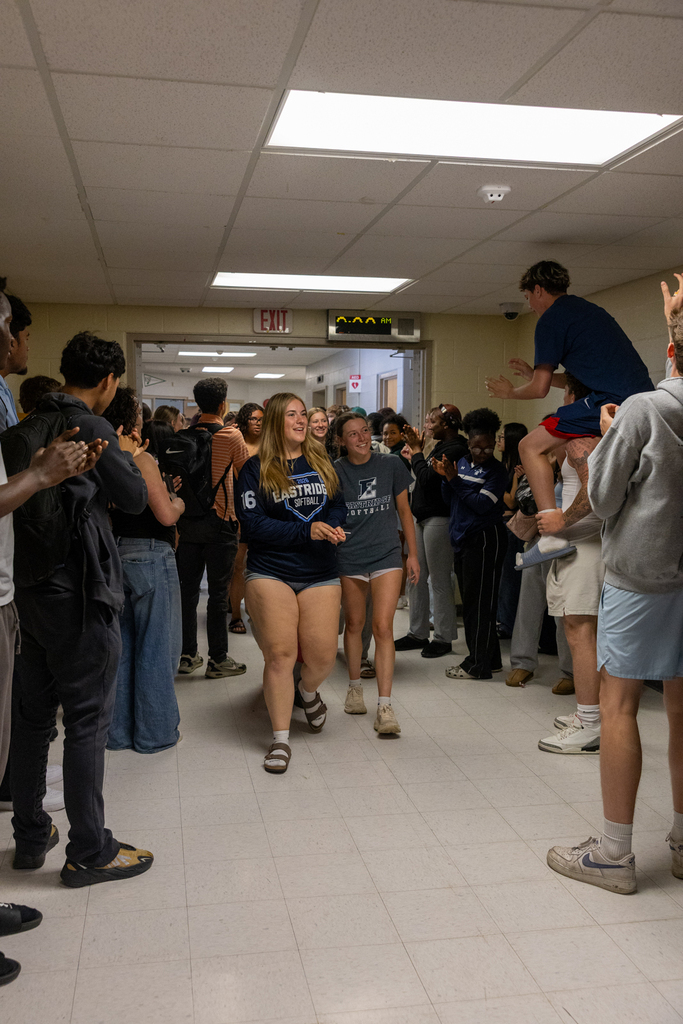 Softball Team walking through the halls being cheered on by staff and students