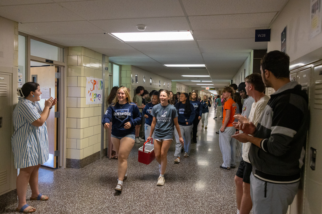 Softball Team walking through the halls being cheered on by staff and students