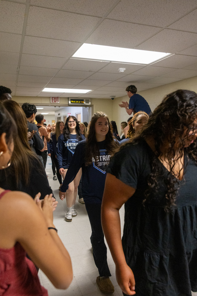 Softball Team walking through the halls being cheered on by staff and students