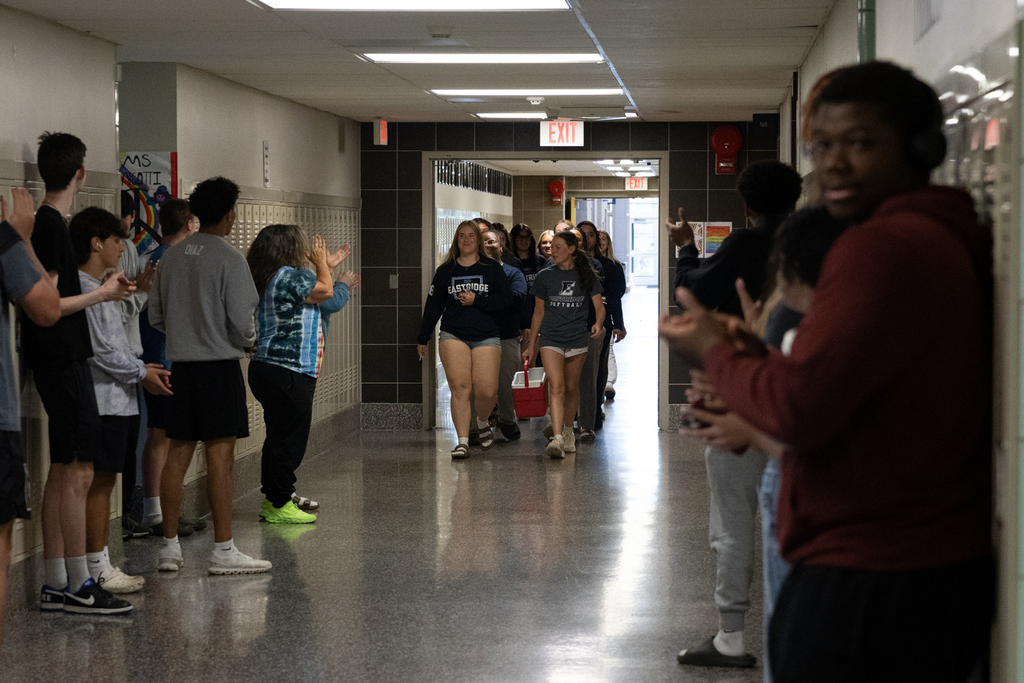 Softball Team walking through the halls being cheered on by staff and students