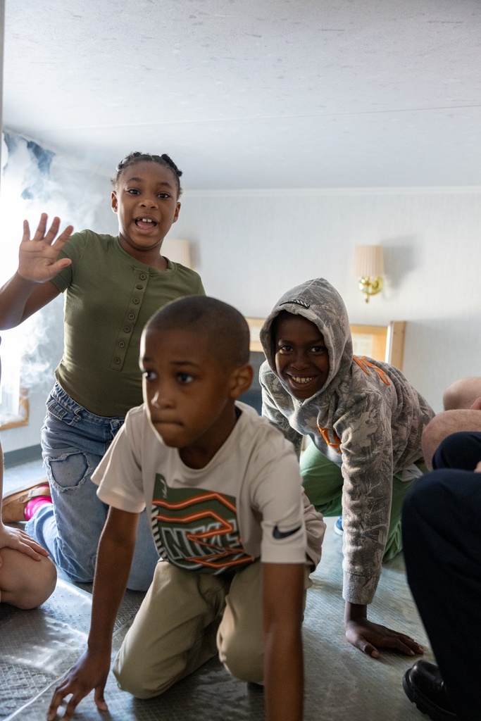 students crawling out of the living room