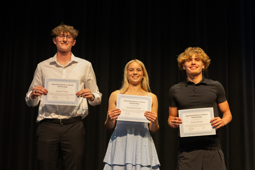 Scholarship winners posing with their certificate