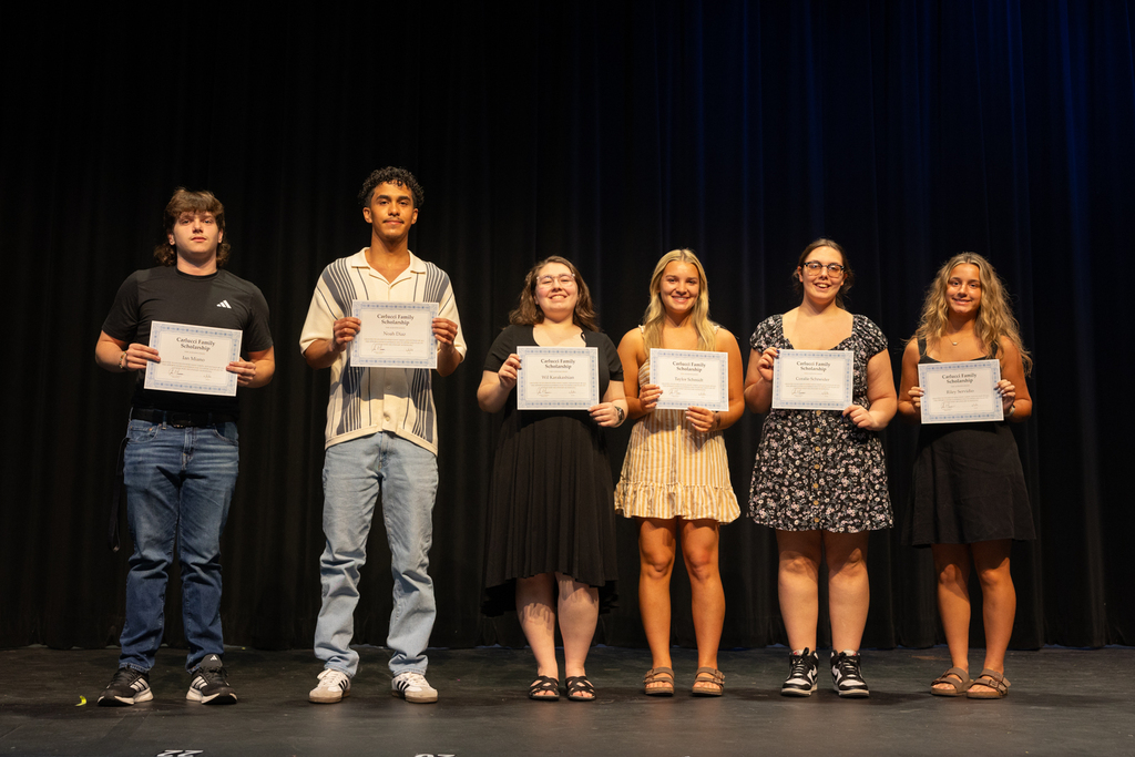 Scholarship winners posing with their certificate