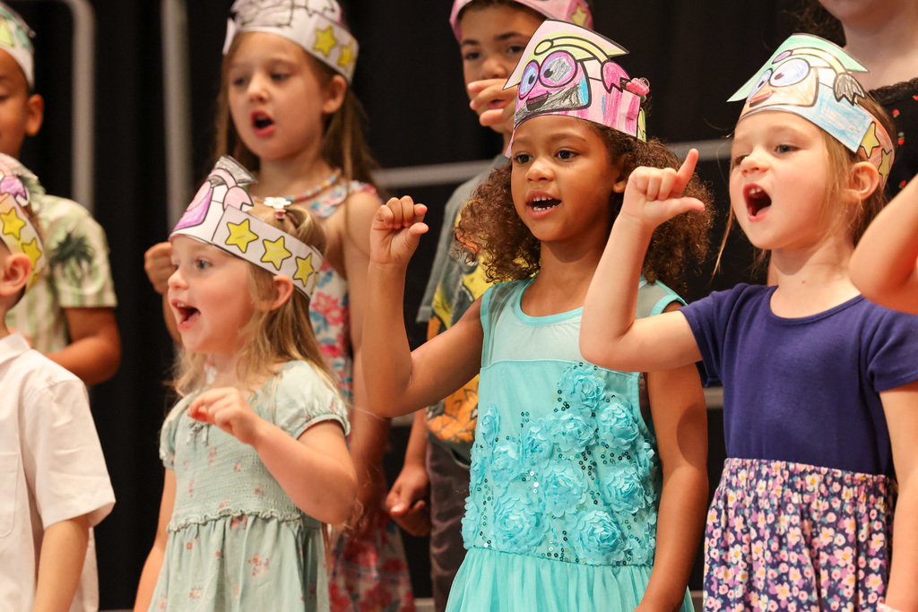 students do sign language on stage