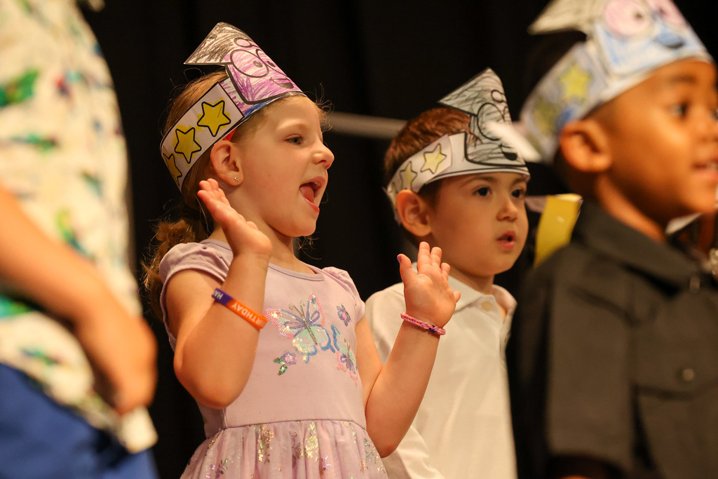 student smiles and dances on stage