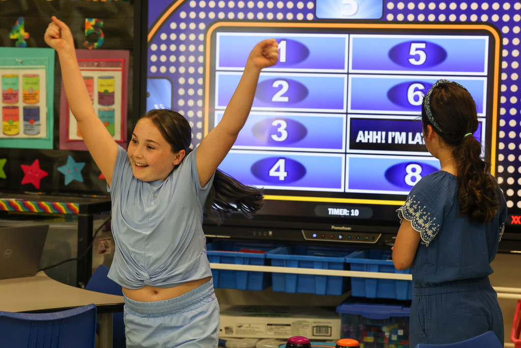 student smiles while winning family feud